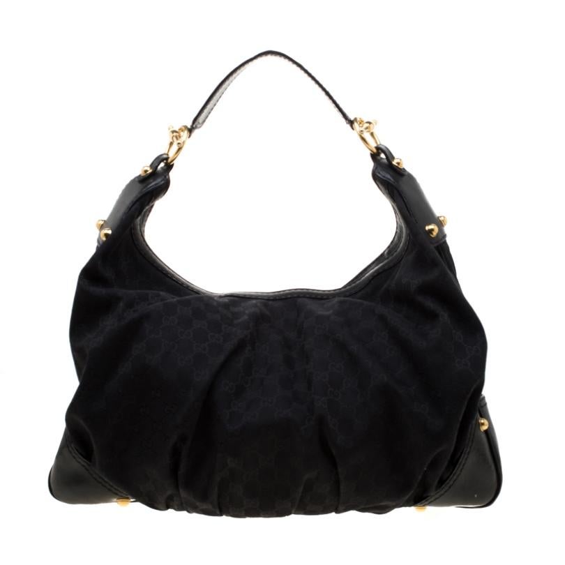 A handbag to last you years in great shape and state is this Jockey hobo from Gucci. Crafted from black leather and canvas in Italy, this gorgeous number has a spacious fabric-lined interior to assist you with ease. It also features a handle that is