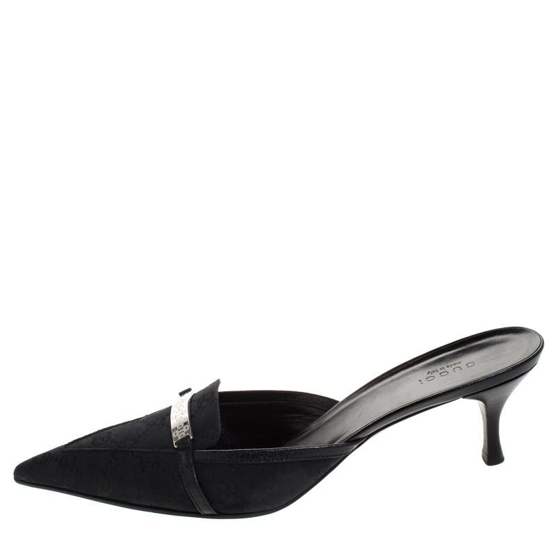How trendy are these mules from Gucci! They carry a classic black exterior made from the signature CC coated canvas and have comfortable insoles. They are complete with pointed toes, metal accents on the vamps and low heels. Team them with your