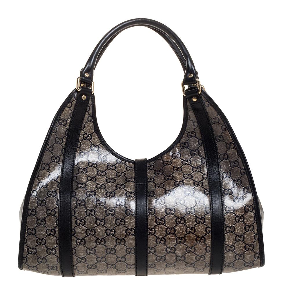 This chic and feminine tote is from Gucci. The bag is made from classic GG coated crystal canvas as well as leather and features a lobster clasp that opens to a fabric-lined interior that can fit your daily essentials with ease. Flaunt this beauty