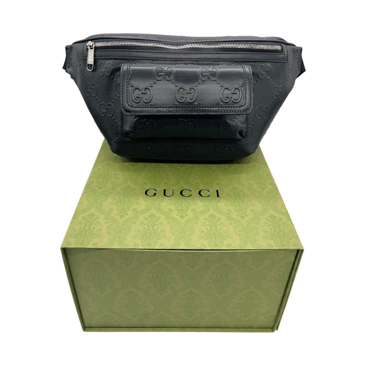 We are offering this very stylish Gucci 100 belt bag that connects the fashion house's past and present. It is finely crafted of a luxurious black leather base with Guccio Gucci's 'GG' monogram logo embossed all throughout the exterior. The bag
