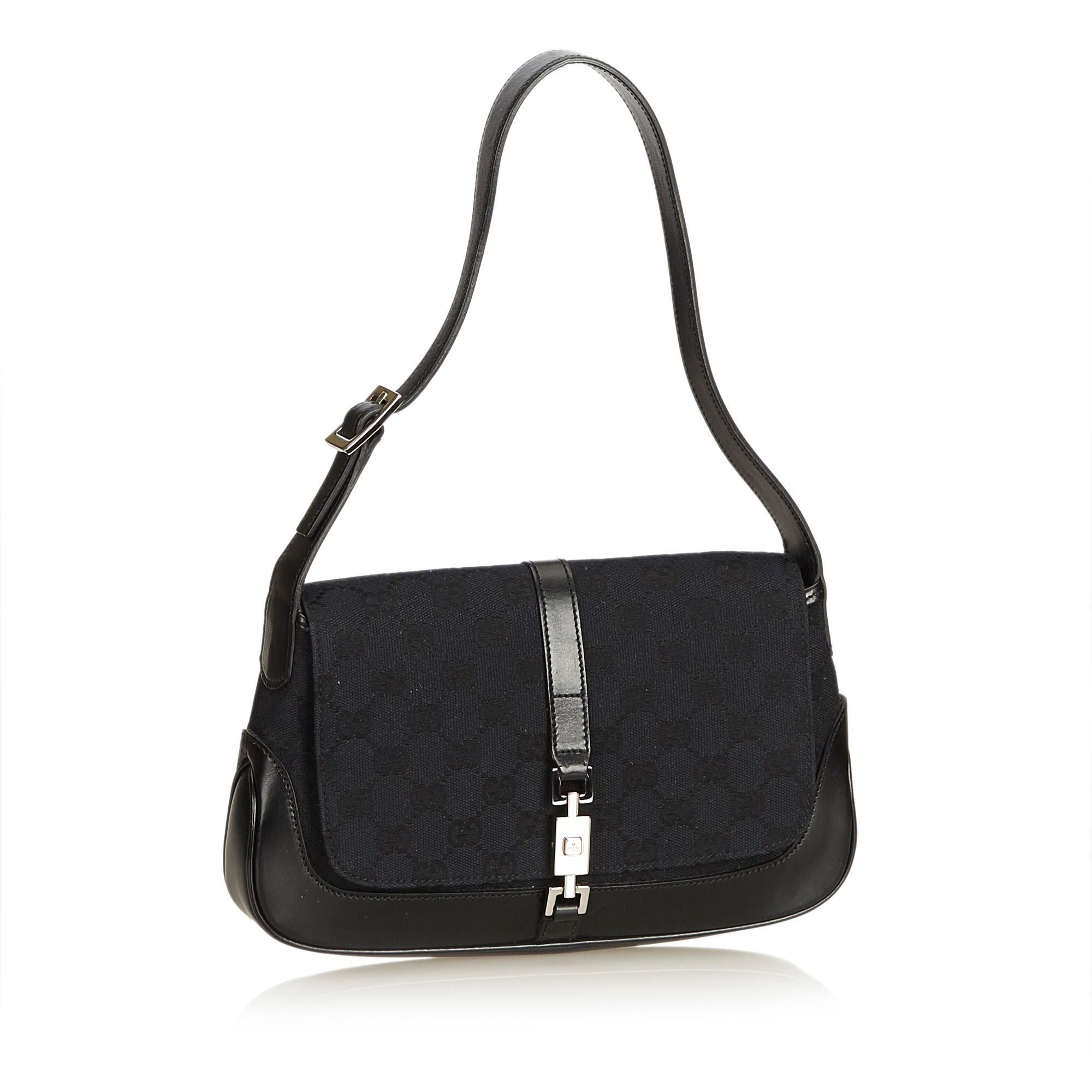 This Jackie features a jacquard body with leather trim, flat leather strap, front flap with flat strap and push lock closure and interior zip pocket. It carries as AB condition rating.

Inclusions: 
Dust Bag

Dimensions:
Length: 17.00 cm
Width: