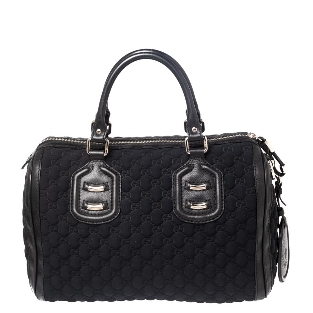 This classy Joy Boston bag by Gucci is a buy you won't regret. Crafted from GG neoprene and styled with leather trims, the bag has a well-sized nylon interior and two top handles. The piece is complete with the brand label on the front.

