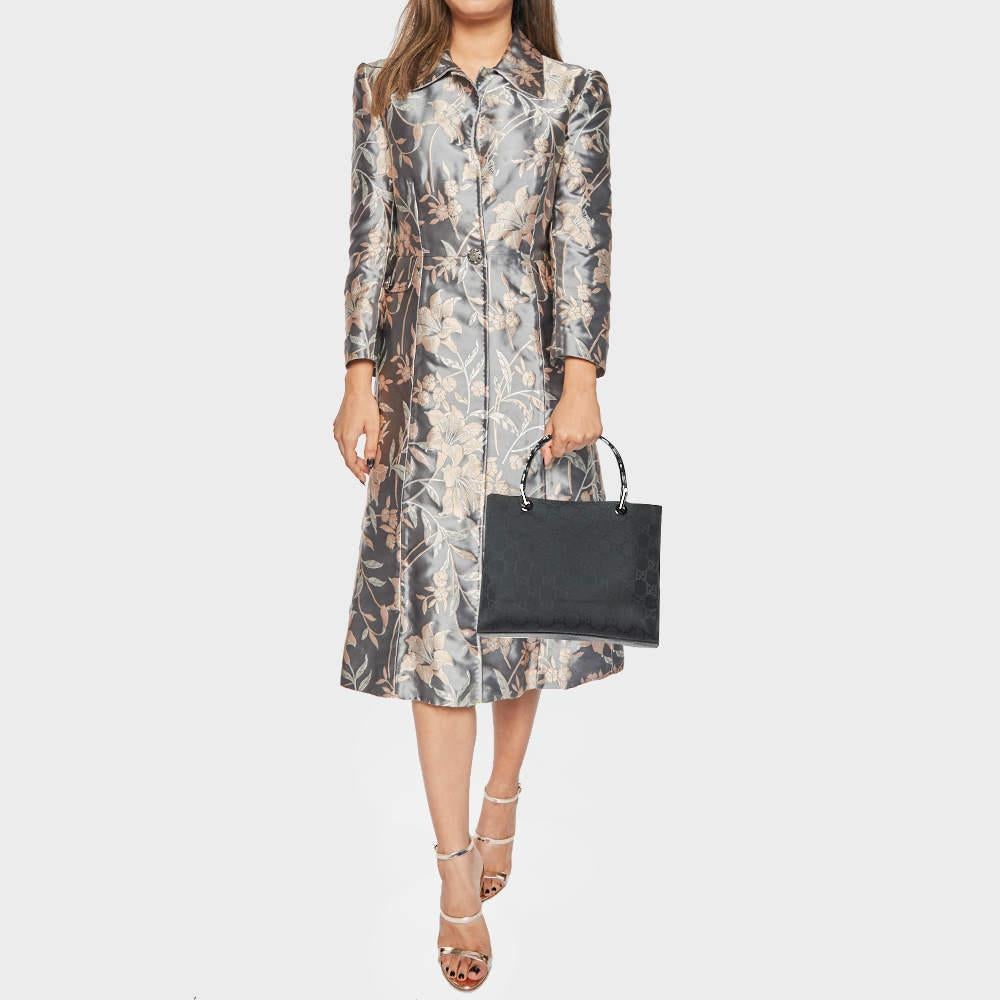 Fall in love with this chic Bamboo tote by Gucci. The bag is crafted from GG printed nylon and has lightweight bamboo handles. It features a spacious fabric lined interior with enough space to accommodate your essentials.