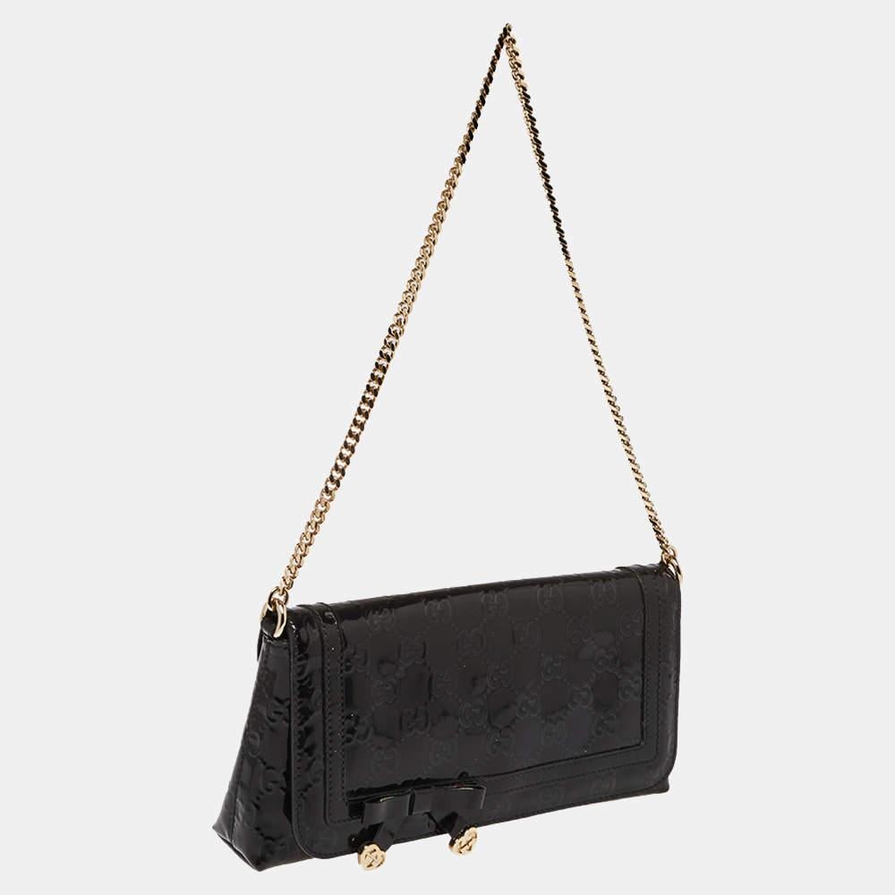 This clutch from Gucci is absolutely lovely! It is crafted from GG patent leather and features a chic silhouette. It has been styled with a bow on the front flap and opens to a suede interior that has enough space to hold your cash, cards, and keys.