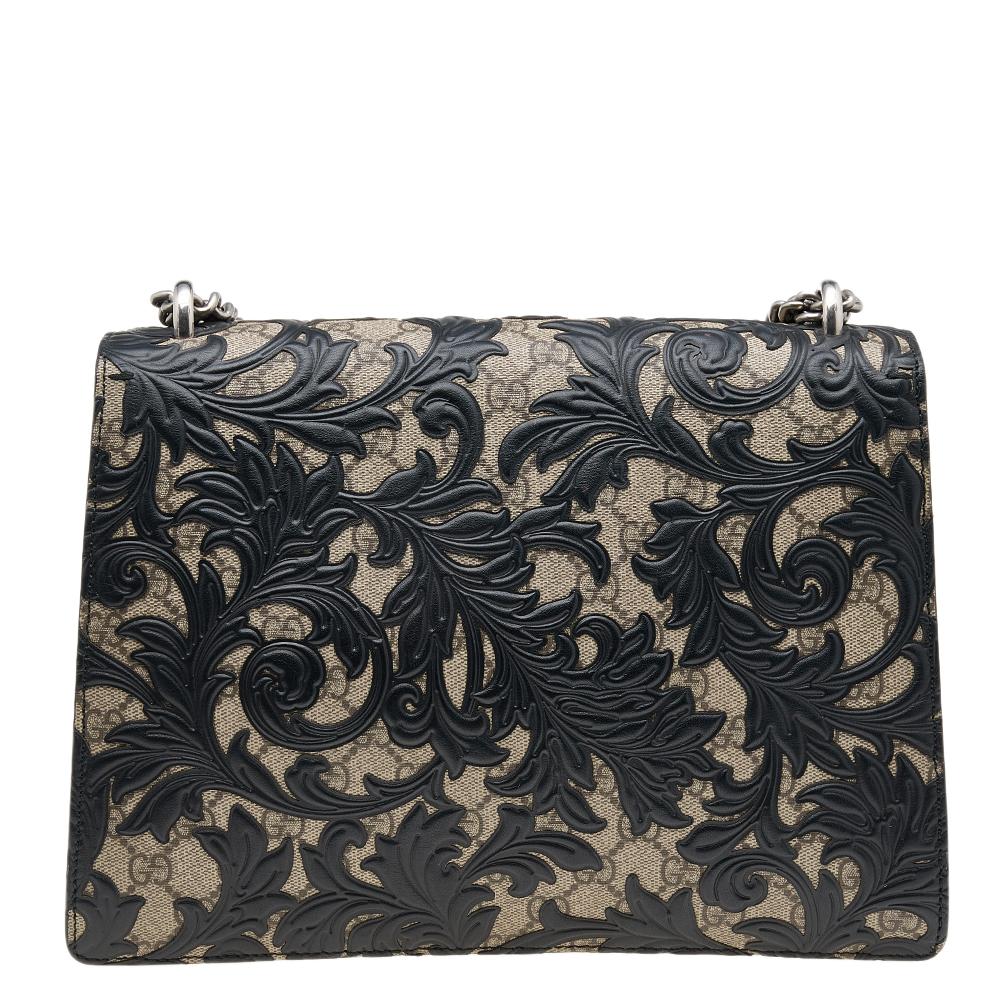 Gucci's inspiration for creating such effortlessly charming and feminine collections comes from the House's rich and varied history. This Dionysus shoulder bag from Gucci exhibits black GG Supreme canvas and leather, which is garnished by the