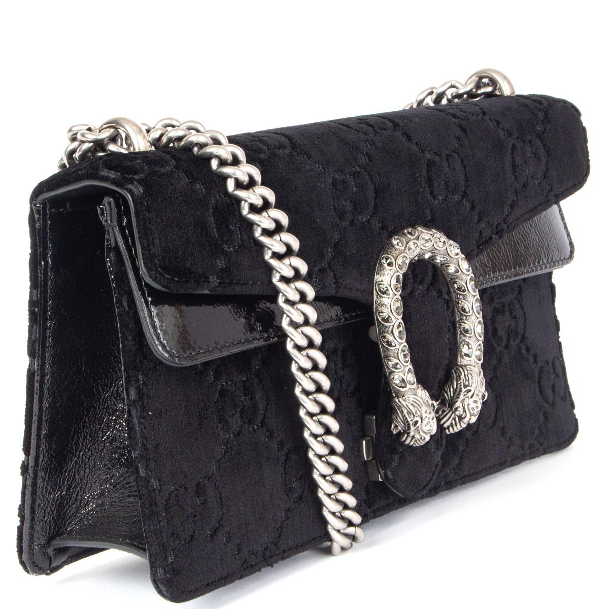 100% authentic Gucci 'Dionysus' small shoulder bag in black monogram embossed velvet and patent leather featuring the classic silver-tone tiger's head clasp embellished with crystals. - It's inspired by the ancient Greek god Dionysus. Opens with