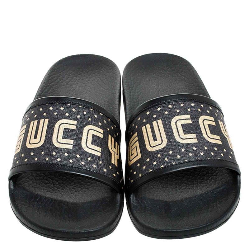 These fun slip-on slides by Gucci are a wardrobe staple. Fashioned out of black coated canvas, they are the epitome of comfortable and stylish fashion. The brand's logo appears in gold and is showcased on the straps. They are lined with leather.