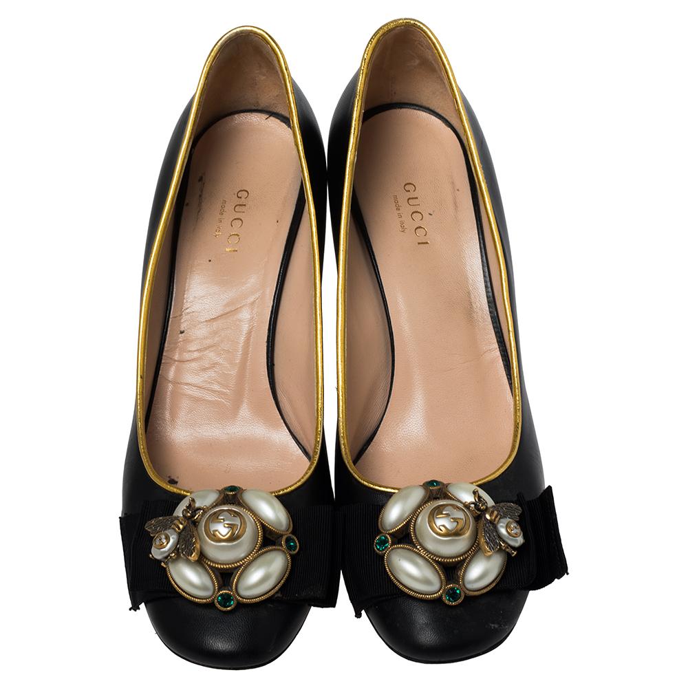 Add the right slant of style with these Gucci pumps. The pre-loved designer black leather pumps feature Gucci's bee motif and pearls over the toes, gold leather edging, and block heels for a comfortable lift.

Includes: Original Box, Info Booklet,