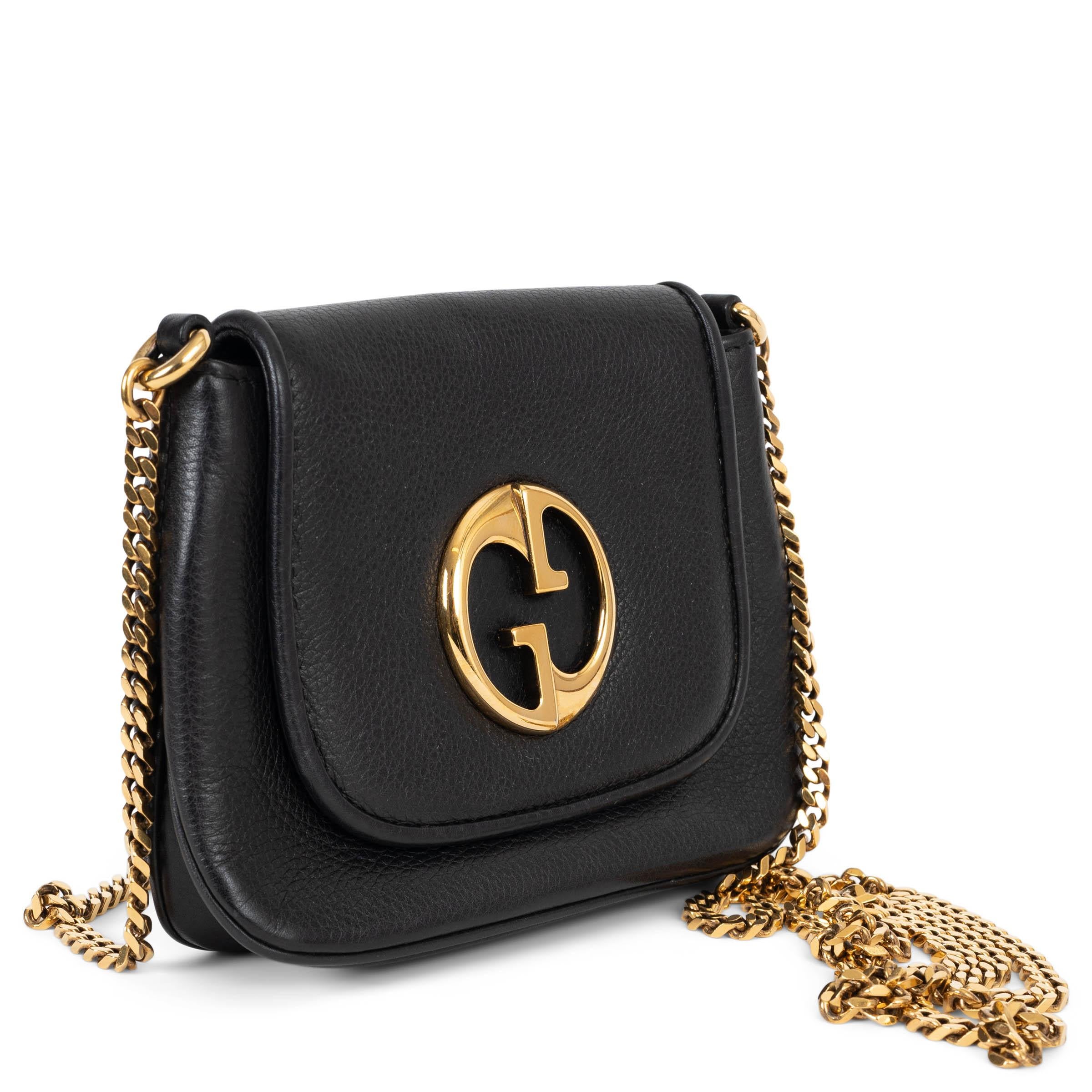 This 100% authentic Gucci 1973 Small Chain shoulder bag in black grained leather is a timeless expression of the house’s heritage. Featuring the iconic 1973 interlocking G detail, it opens with a magnetic-snap closure beneath the front flap. The