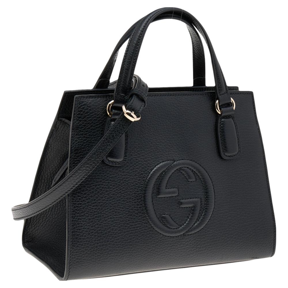Constructed in black grain leather, this Gucci Soho satchel features double handles, a shoulder strap, and a front interlocking G. The bag's top zipper opens to a spacious interior lined with canvas.

Includes: Original Dustbag, Info Booklet,