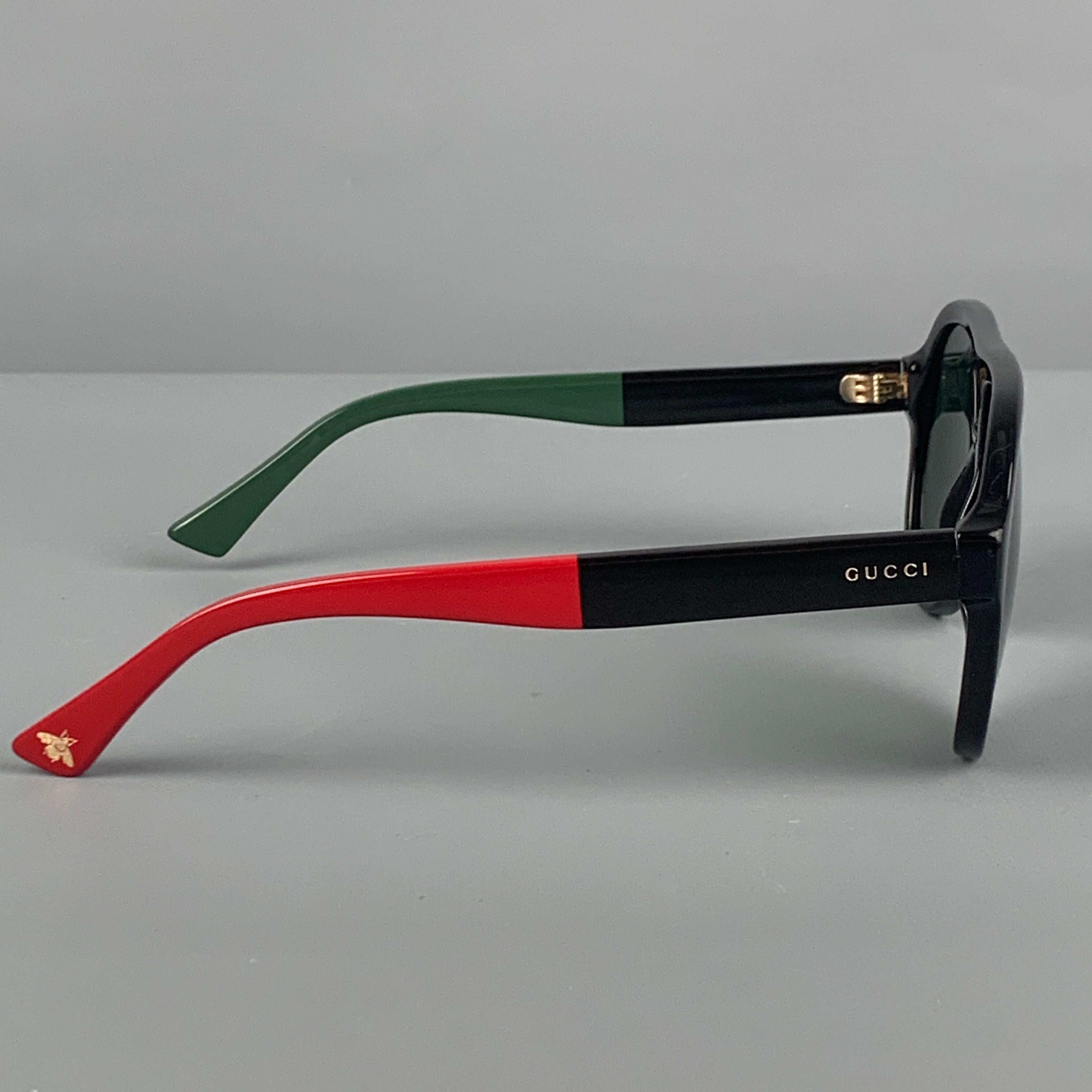 GUCCI sunglasses comes in a black acetate with a red & green color block design featuring a aviator style and tinted lenses. Made in Italy. 

Very Good Pre-Owned Condition.
Marked: GG0159S

Measurements:

Length: 5.5 in.
Height: 2.25 in. 