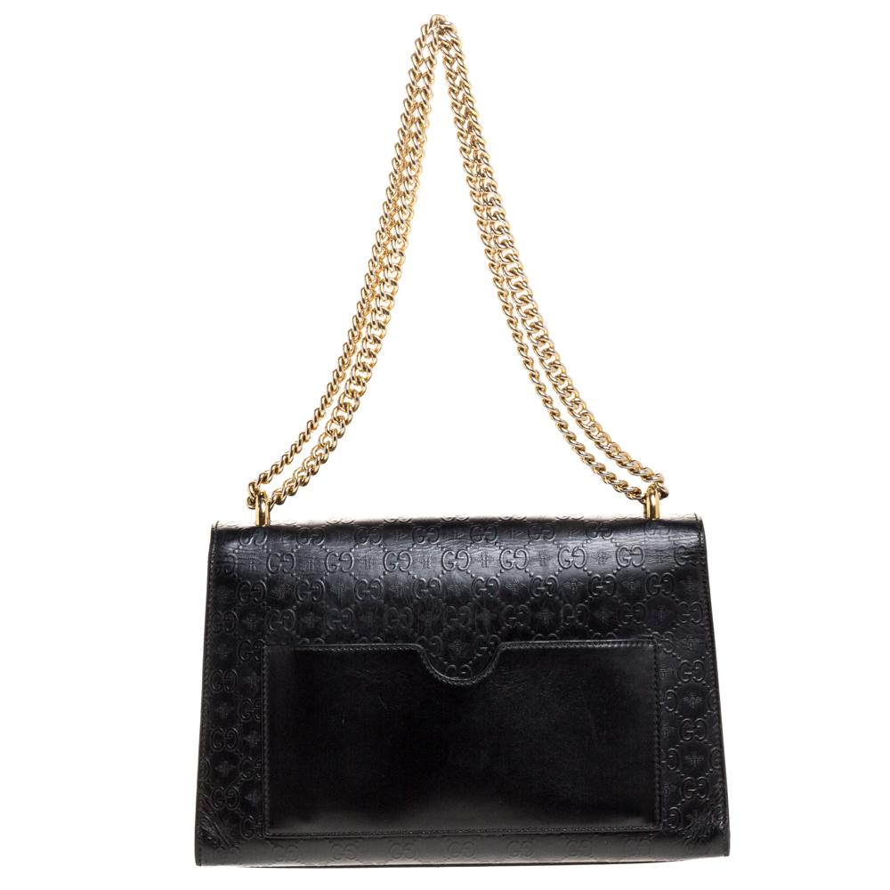 Swing this gorgeous bag and fetch endless compliments. This Gucci creation has been beautifully crafted from black Guccissima leather with bee motifs all over and a flap that carries a signature padlock. The insides are lined with suede and sized to