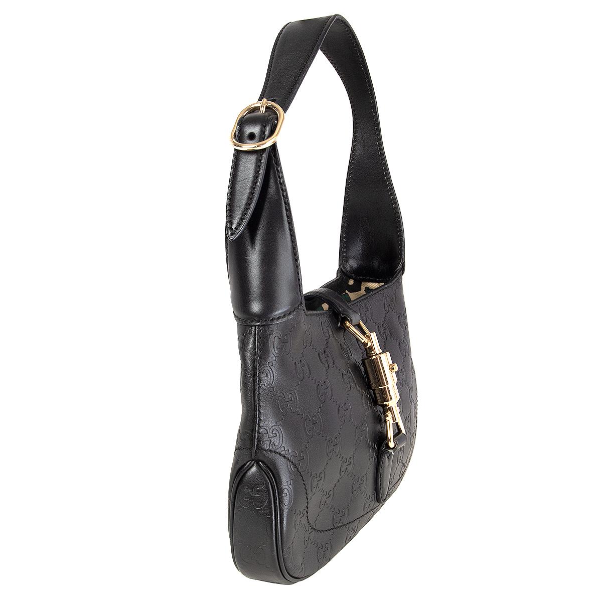 Gucci 'Jackie O' mini bag in black Guccissima calfskin featuring a round light gold-tone closure. Lined in horsebit printed canvas with one zipper pocket against the back. Has been carried with some faint scratches to the hardware. Overall in