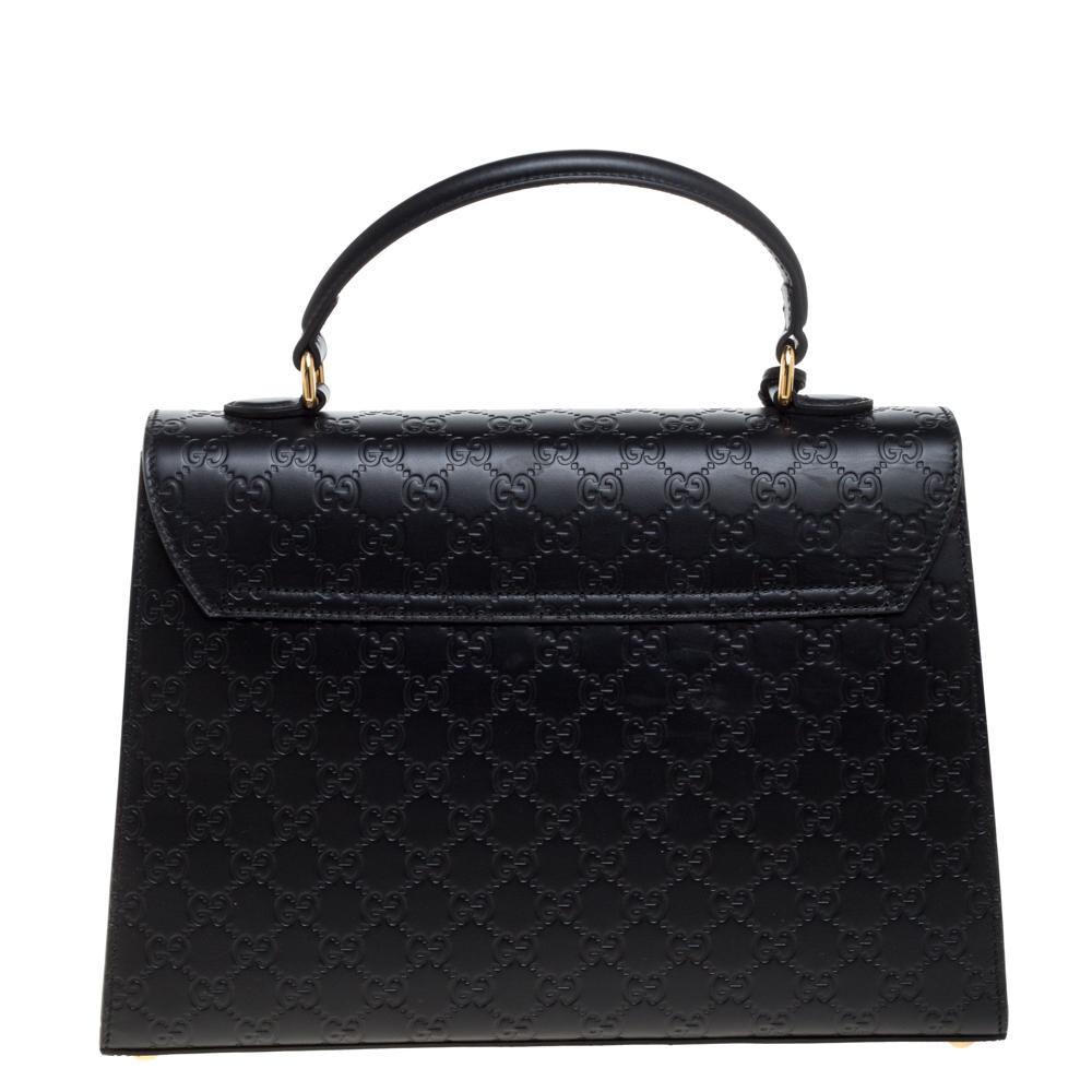 This black bag from Gucci is sure to add sparks of luxury to your wardrobe! It is crafted from the signature Guccissima leather and features a single top handle with an attached clochette. It flaunts a front flap with a gold-tone closure to secure