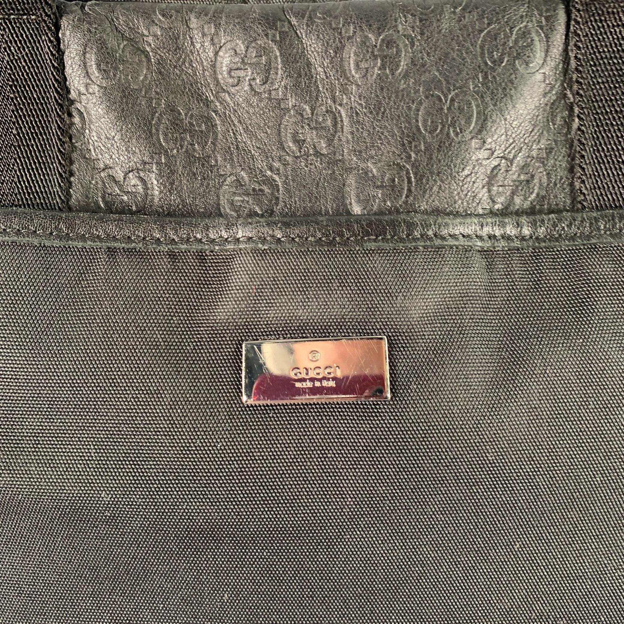 GUCCI messenger bag
in a black nylon featuring black leather Guccisima monogram embossed trim, top handles with adjustable crossbody strap, and zip closure. Made in Italy.Very Good Pre-Owned Condition. 

Marked:   170061 200047 

Measurements: 
 