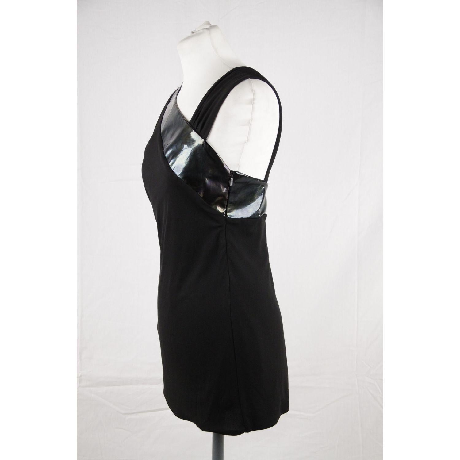 MATERIAL: Viscose COLOR: Black MODEL: Asymmetric Top GENDER: Women SIZE: 42 IT COUNTRY OF MANUFACTURE: Italy Condition CONDITION DETAILS: B :GOOD CONDITION - Some light wear of use - minimal wear on patent leather trim Measurements MEASUREMENTS: