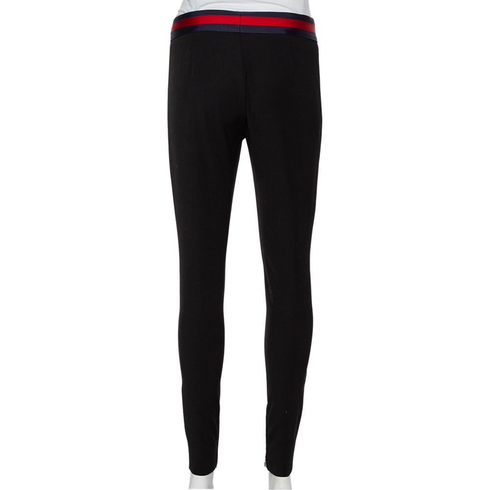 These Gucci leggings are the perfect pair of bottoms to complement any top you choose for your outfit. Crafted from black knit with contrast trim waist bow detail, these leggings are comfortable and luxe at the same time. The iconic Gucci web design