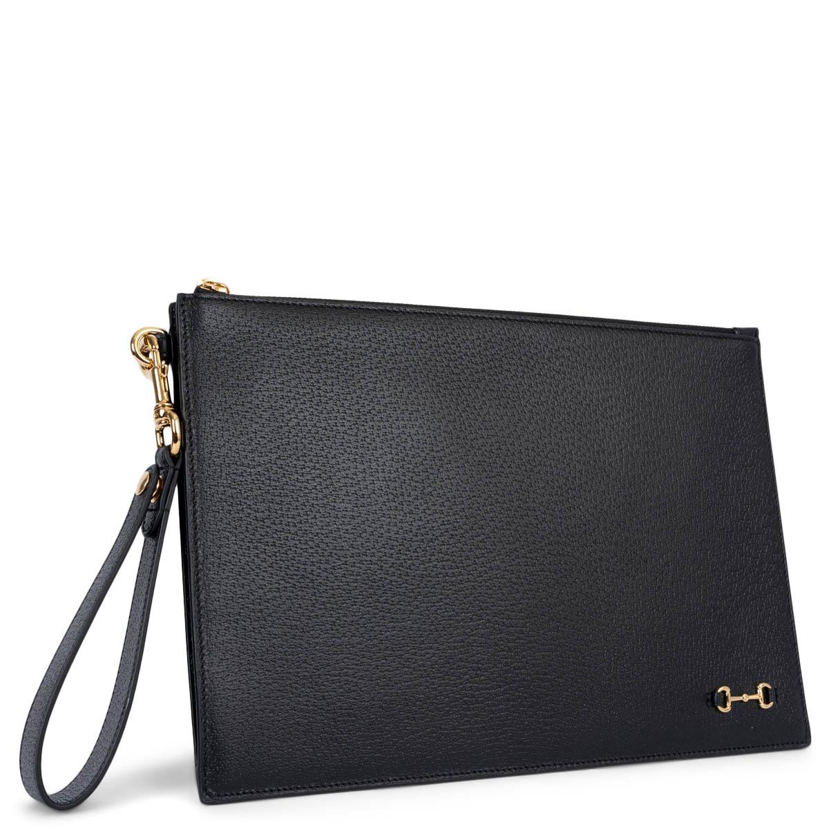100% authentic Gucci 1955 Horsebit wristlet zip pouch in black pigskin featuring gold-tone hardware. The design comes with a zipper closure and is lined in black monogram canvas with two open pocket against the front and six credit card slots