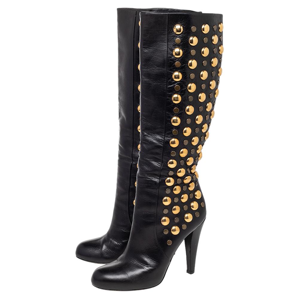 Step out and catch everyone's attention when you slip on these Babouska boots by the iconic house of Gucci. They are made from quality leather in Italy, come in a classic shade of black, and feature striking brass-tone studded shafts. These 11 cm