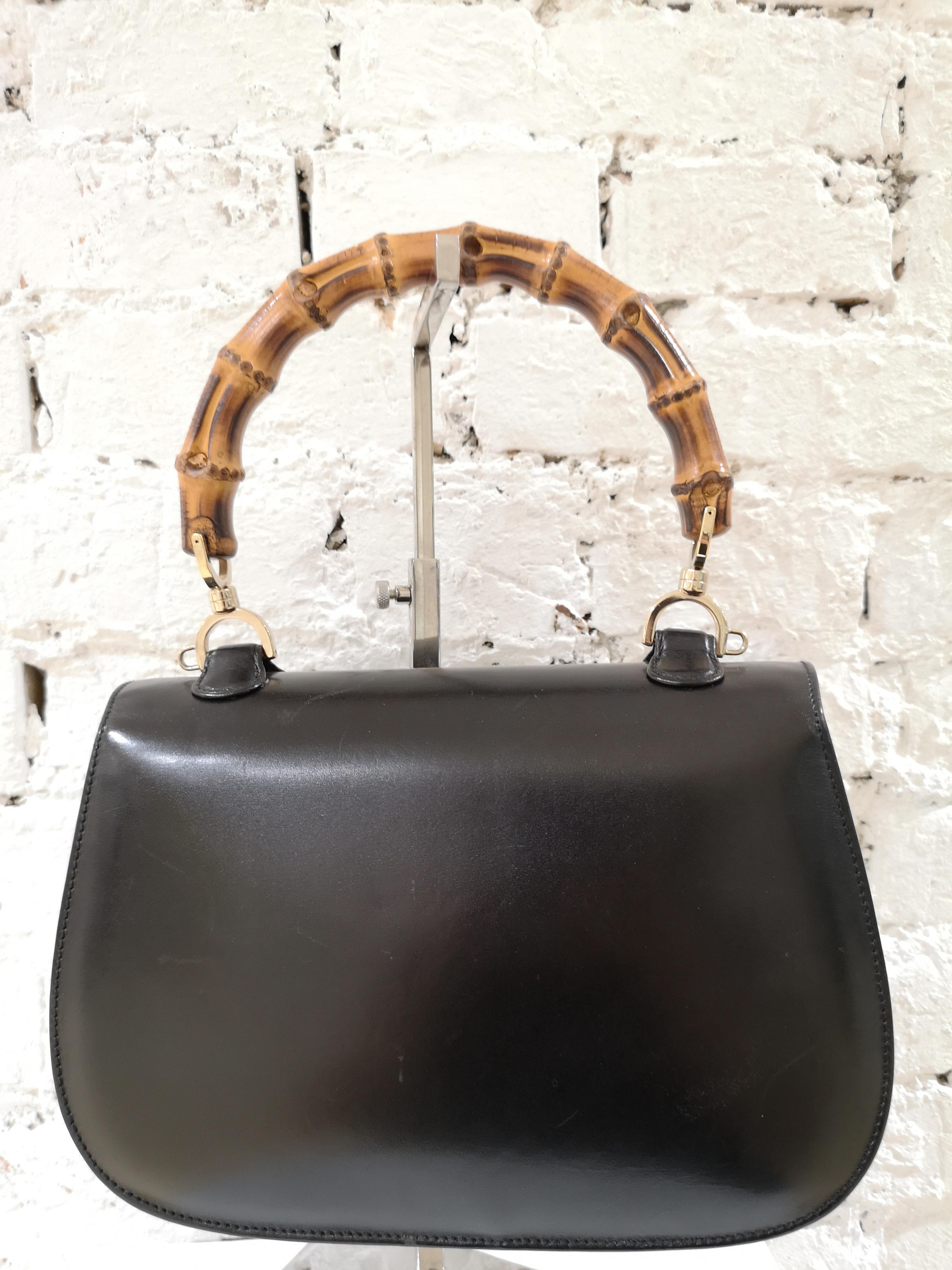Gucci Black Leather Bamboo Bag
Black leather Bamboo Line 2-way handbag from Gucci Vintage featuring a detachable and adjustable shoulder strap, a foldover top, an internal zipped pocket, a curved silhouette and a brown bamboo top handle. 