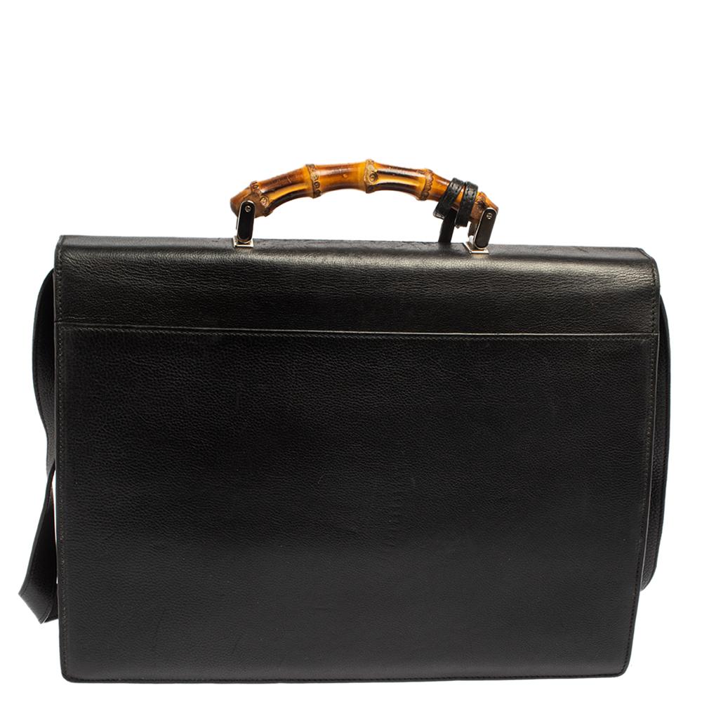 Bags like this briefcase from Gucci are not only symbols of style but also reliability. Crafted from black leather, this creation features the signature bamboo motif as the top handle and a silver-tone clasp on the front. The flap opens to reveal a