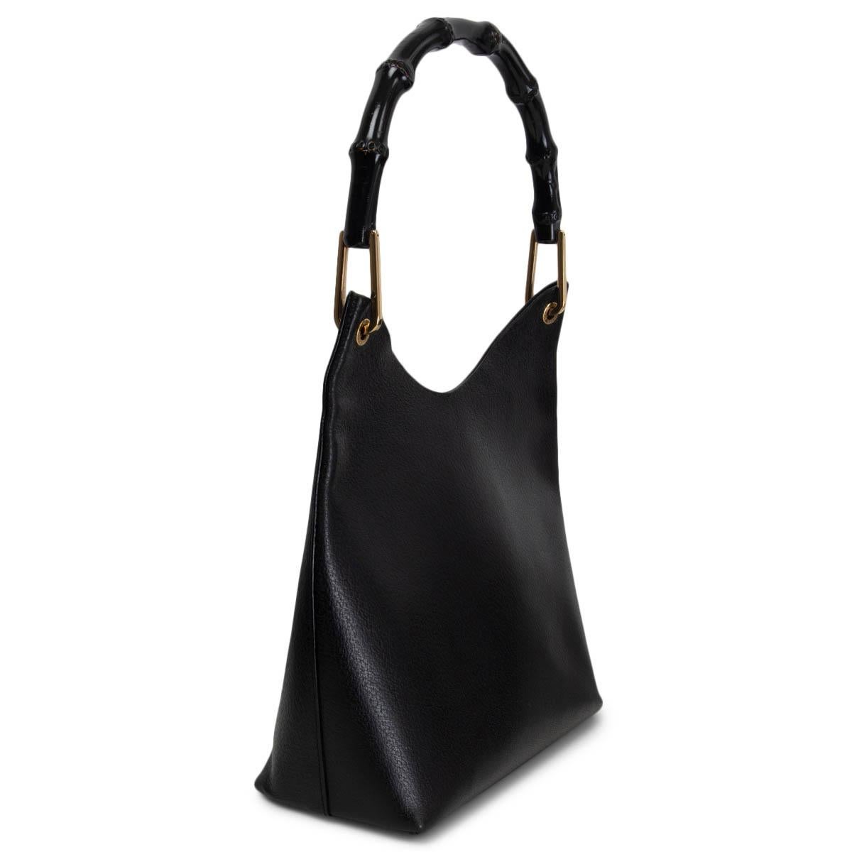 100% authentic Gucci by Tom Ford Bamboo hobo bag in black pigskin leather featuring black bamboo handle.  Lined in black suede with an attached pouch inside and gold-tone hardware. Has been carried and the inside pouch has a small blue stain inside.