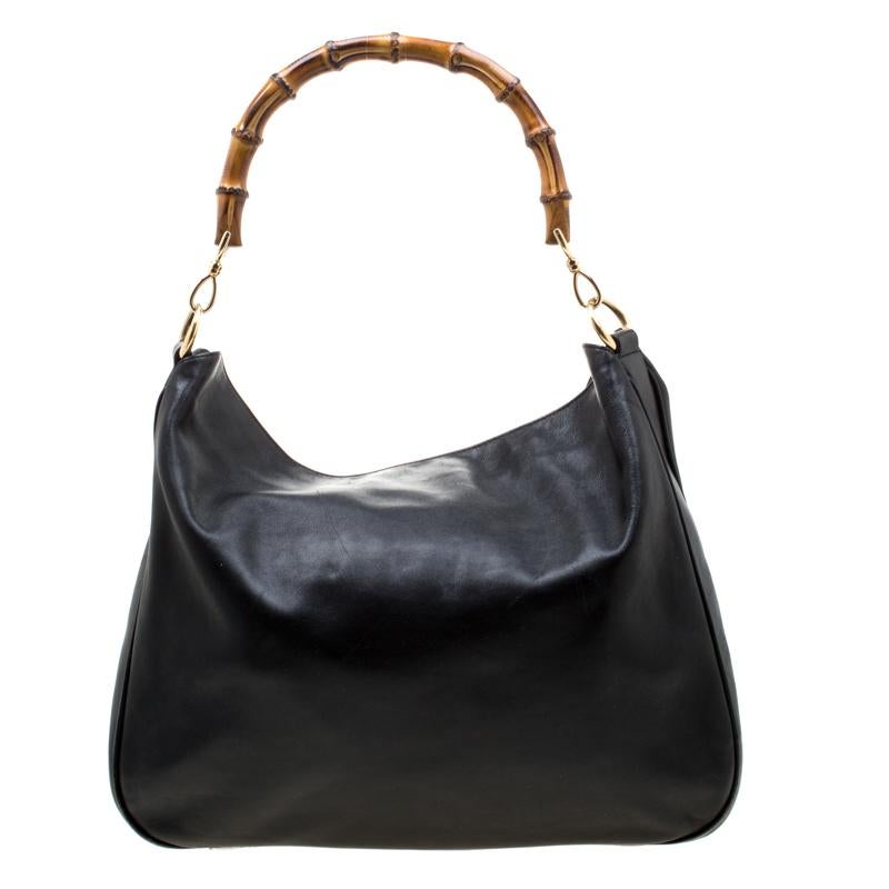 Experience the touch of fine craftsmanship with this immaculately crafted Gucci bag. Made from leather the bag features a buttoned closure that secures a spacious interior. Incorporate a touch of lovely to your look with this black bag that is