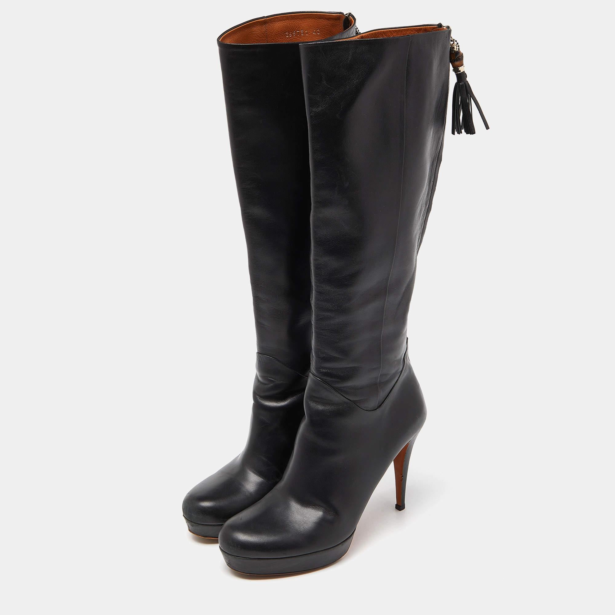 Gucci brings you this fabulous pair of knee length boots that will give you confidence and loads of style. They've been crafted from leather in a classy black shade and styled with platforms, 11cm heels and back zippers with bamboo tassel pull.