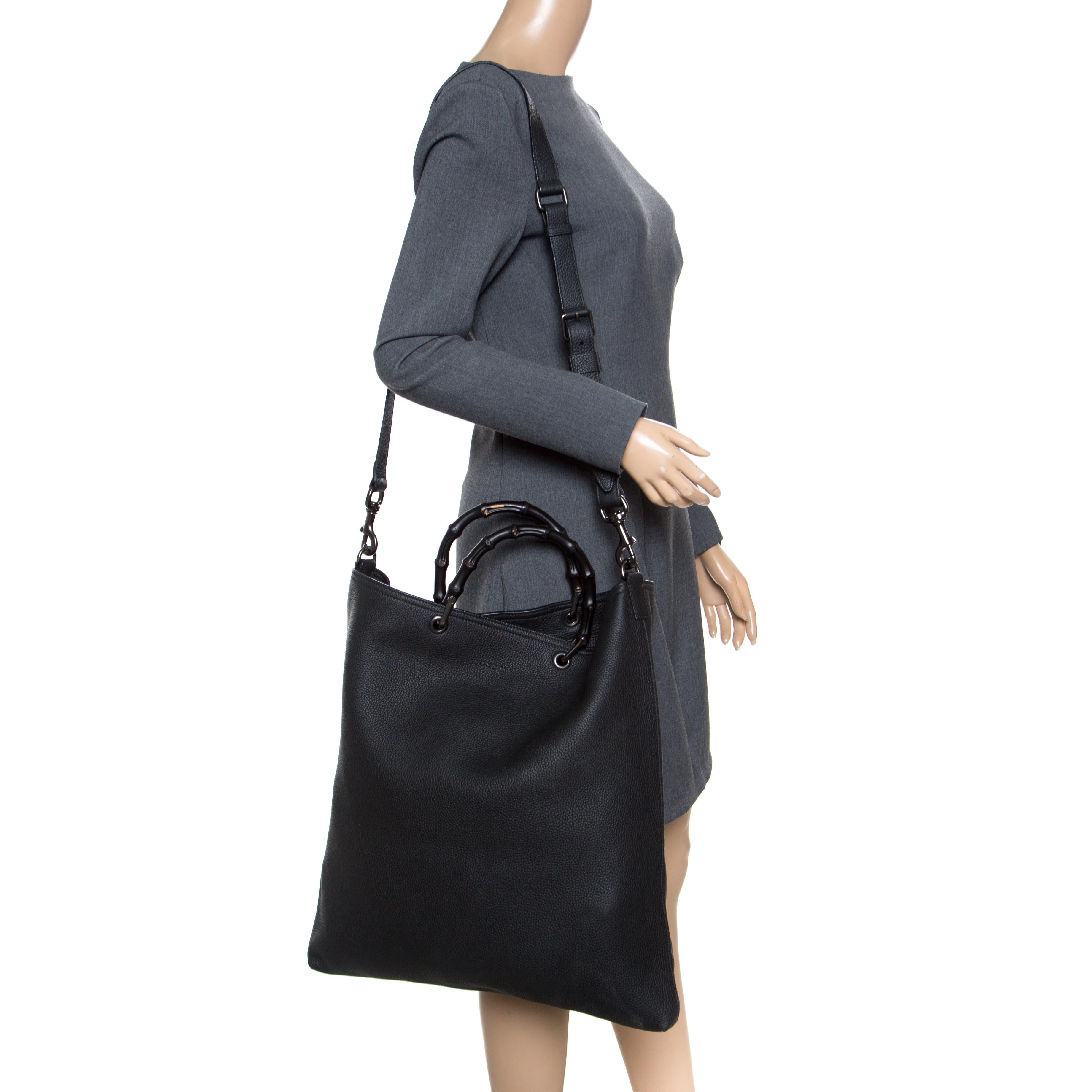 Handbags as fabulous as this one are hard to come by. Crafted from black leather, this stunning number features two bamboo handles and a detachable shoulder strap. The spacious suede interior will safely hold your necessities. The bag is a creation