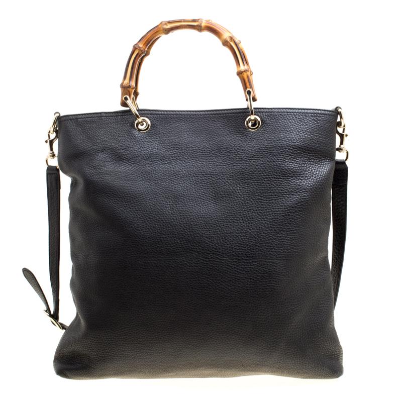 This Gucci bag combines style and elegance into the ultimate everyday bag. Crafted from black leather, it is accented with signature bamboo top handles. Secured with a magnetic closure, the interior is lined with canvas and has one zipped pocket.