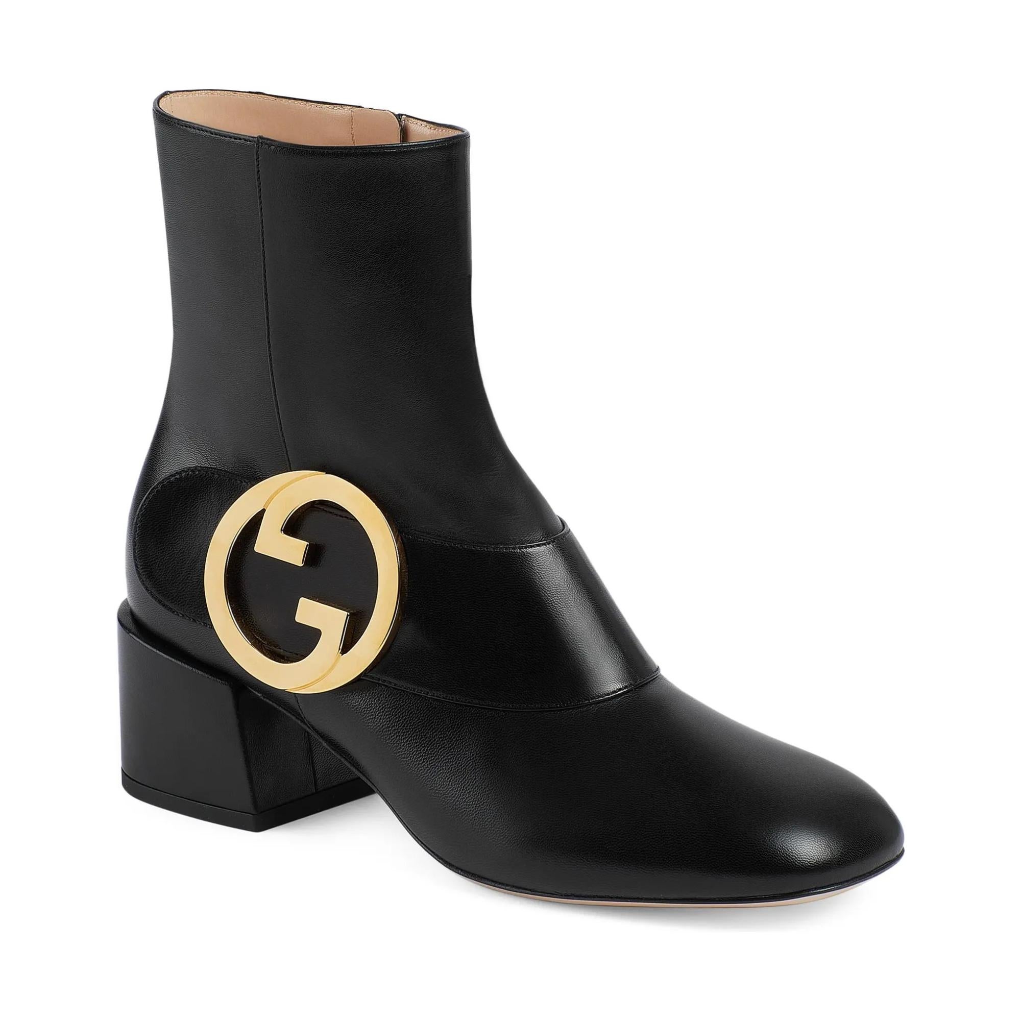 The design for this boot was inspired from 1970's archive pieces. The boots feature the vintage monogram round interlocking g detail in gold tone hardware. The boots are constructed of black leather with zip closure. The vintage Gucci logo detail