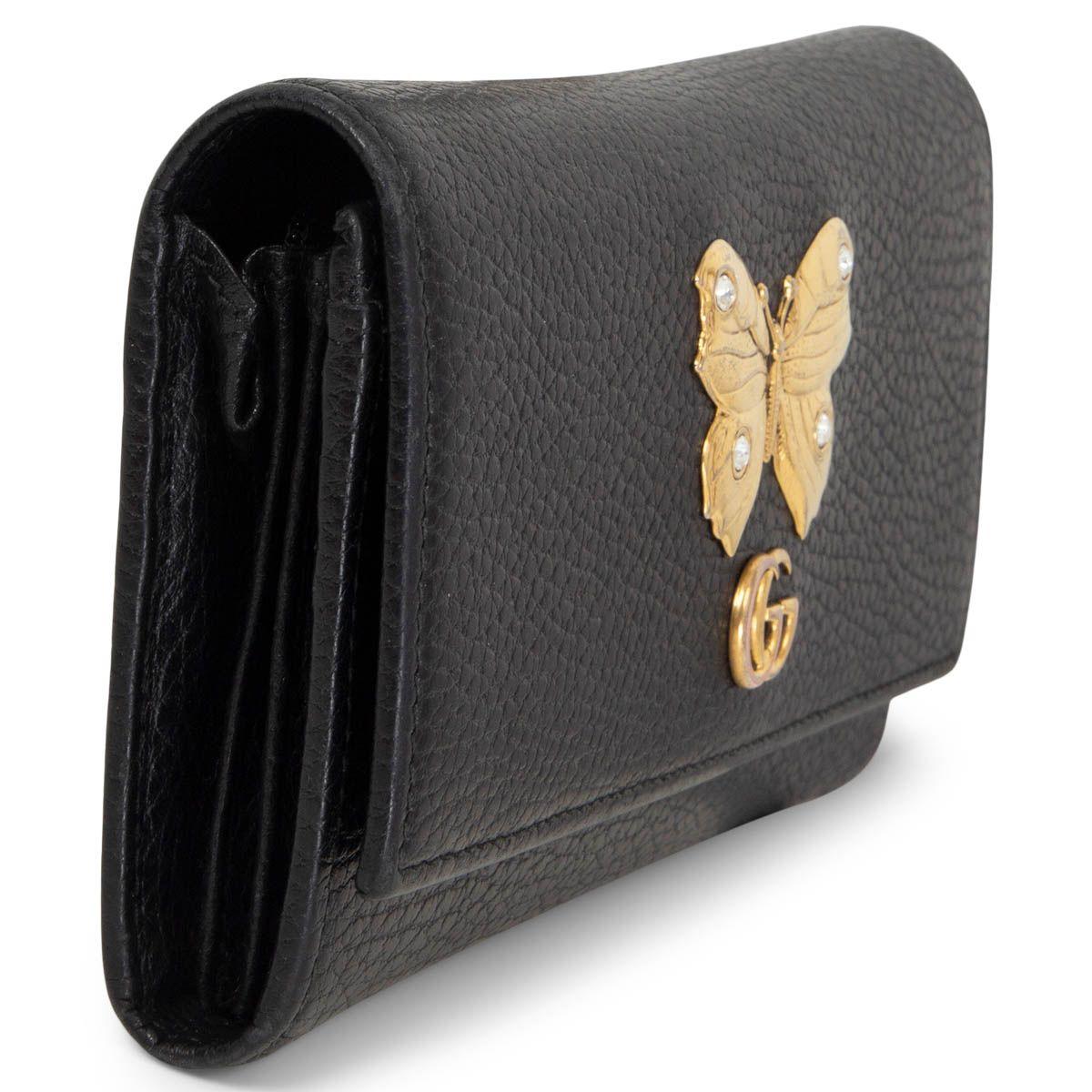 100% authentic Gucci Butterfly Continental wallet in black grained calfskin embellished with a gold-tone metal butterfly with crystals on the wings and GG logo. Opens with a push button and is lined in black calfskin and nylon with 12 credit card