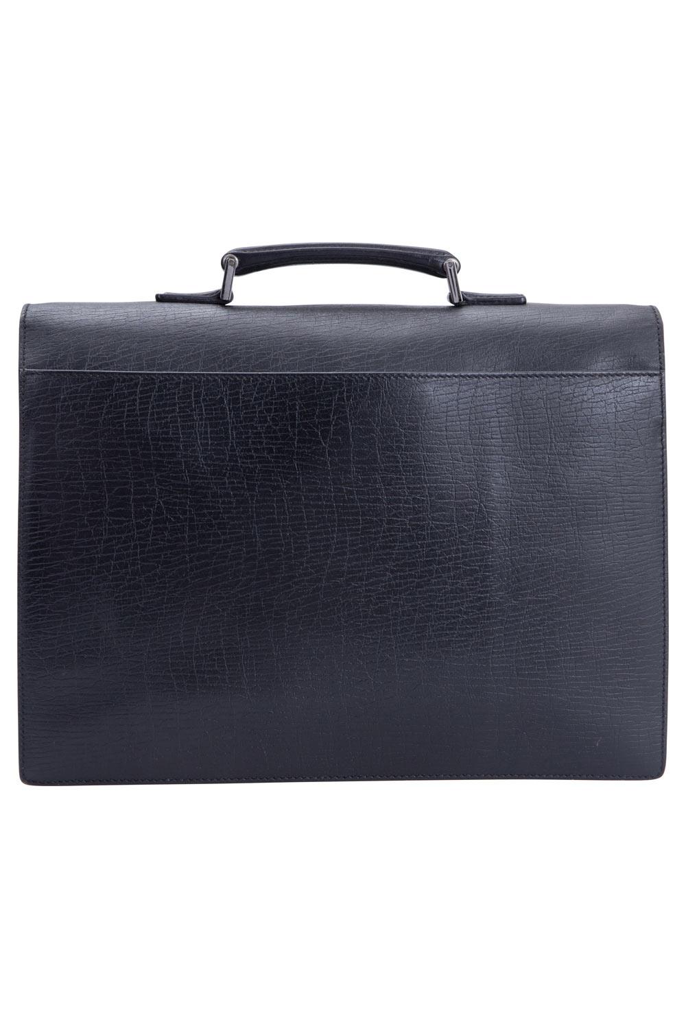 Well-made leather products like this one are not only a symbol of style but also reliability. Crafted from leather, this briefcase by Gucci features a front flap secured by a code lock. The flap opens up to reveal a canvas-lined interior perfectly