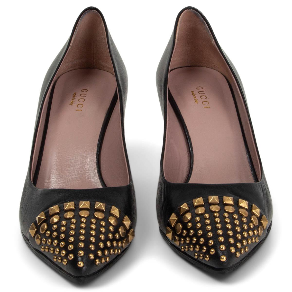 100% authentic Gucci Coline poited-toe pumps in black calfskin featuring gold-tone metal studded cap. Have been worn and are in excellent condition. Black rubber soles have been added. Come with dust bag. 

Measurements
Imprinted Size	37.5
Shoe