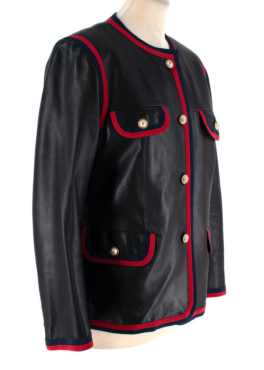 Black Leather Collarless Web-Trimmed Jacket

- Signature collarless style, rendered in a supple black leather trimmed with red and blue webbing
- Button up closure embellished in faux pearls and gold-tone chain hardware
- 4 front flap pockets
-