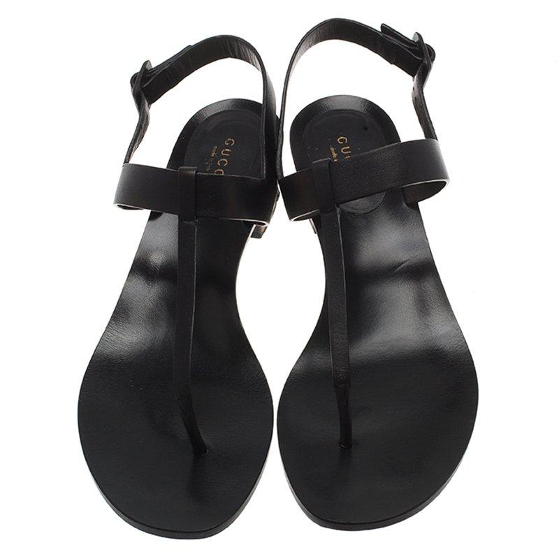 Notable for its feminine precision, Gucci has crafted these thong sandals to have a chic finish. Made in Italy, this pair is crafted from black leather in a minimal thong sandals style with a slingback strap. The block heel is composed of the