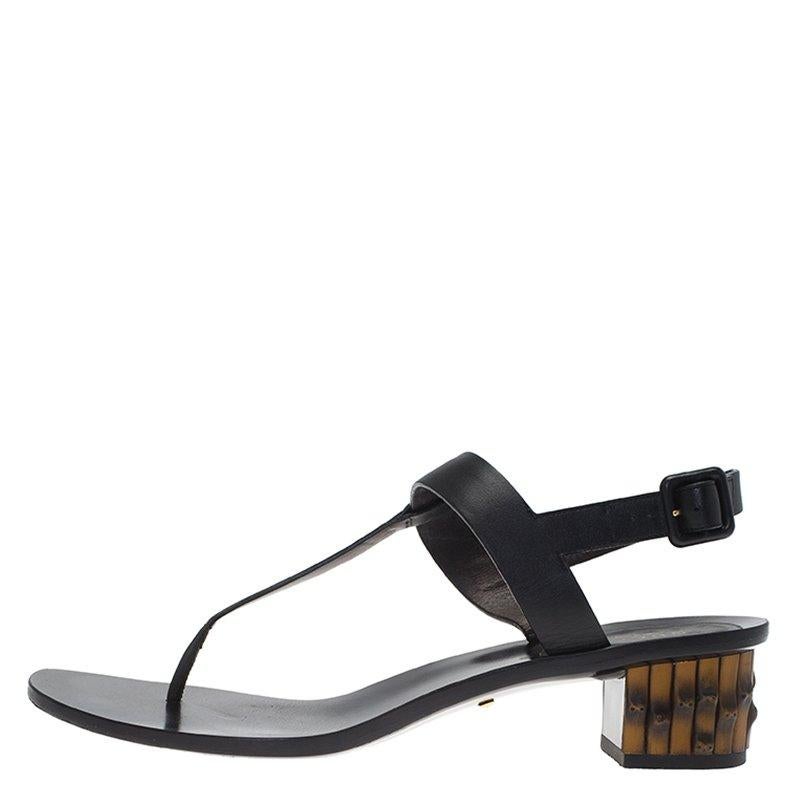 Notable for its feminine precision, Gucci has crafted these thong sandals to have a chic finish. Made in Italy, this pair is crafted from black leather in a minimal thong sandals style with a slingback strap. The block heel is composed of the