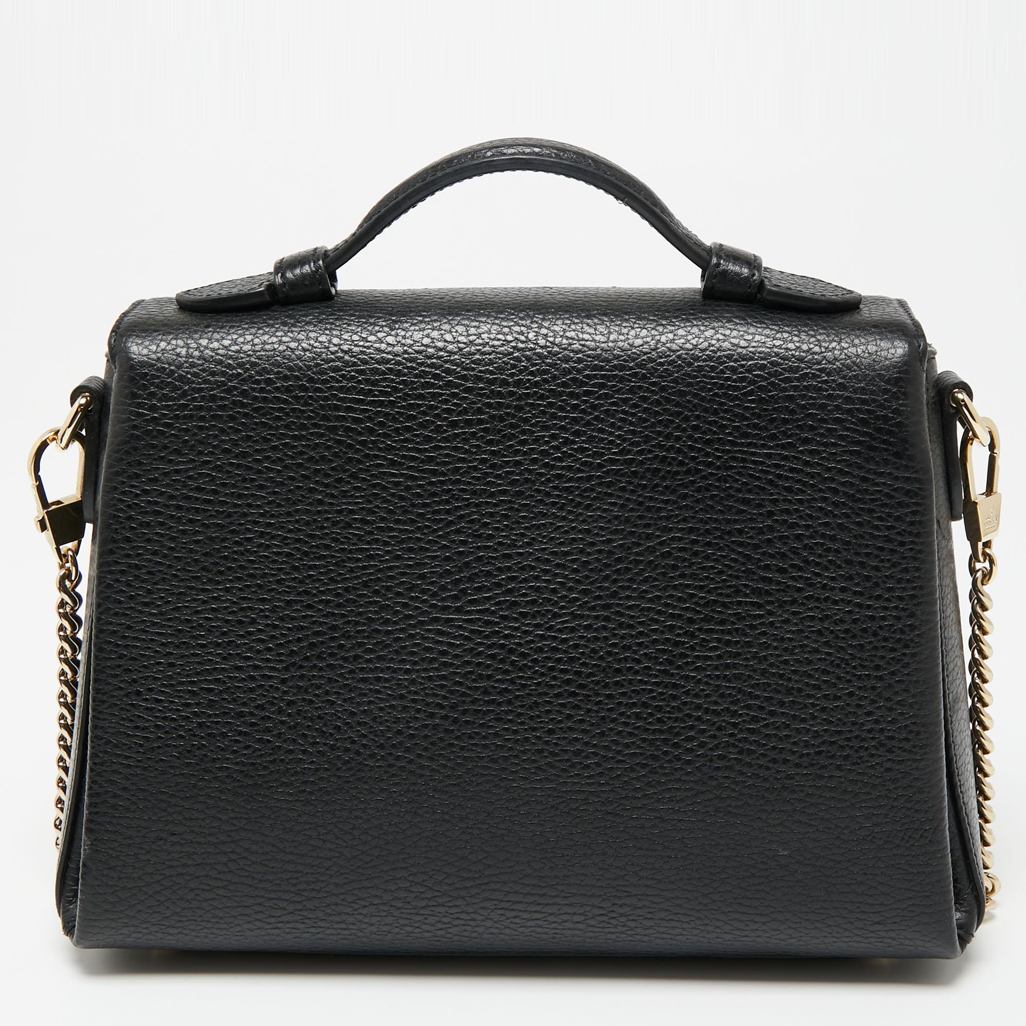Elegance meets luxury in this stunning bag from the House of Gucci. It is created using black leather, with an Interlocking G motif perched on the front. It features a fabric-lined interior, gold-tone hardware, and a sturdy top handle. This gorgeous