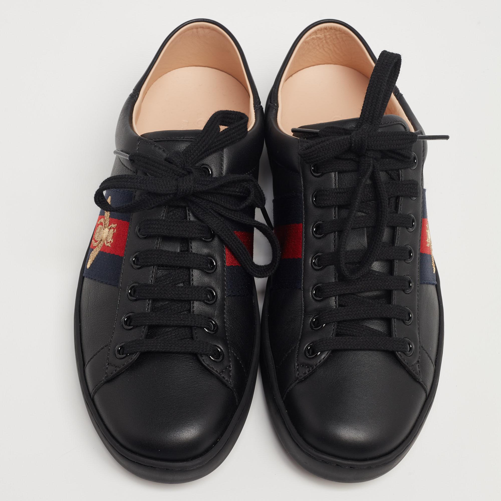 Stacked with signature details, this Gucci pair is made using leather and is designed in a low-top style with lace-up vamps. They have been fashioned with embroidered bee Web stripes on the sides. Complete with comfortable insoles, these shoes can