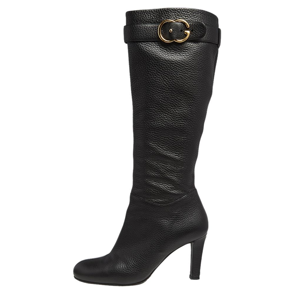 Black boots are closet staples for any woman and what better than one from the house of Gucci? Crafted from leather in a knee-length silhouette, they are designed with GG buckles, round-toes, and are raised on sturdy heels.

Includes: Original
