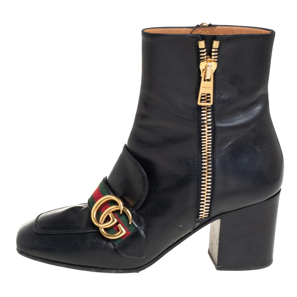 Crafted exquisitely from black leather, these Gucci boots were built to lift your outfits and your style. They carry square toes, side zippers, and GG Web details on the uppers. The insoles are lined with leather and overall, the pair looks just