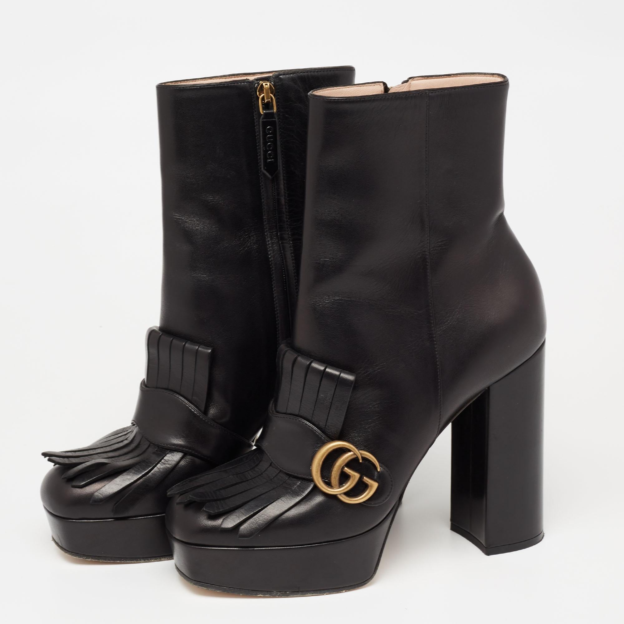 Indulge yourself in a luxurious experience with these Gucci boots. A perfect stylish accessory, they come made from black leather and flaunt side zipper closure. The interlocking 'GG' motif on the folded fringe acts as a recognizable sign-off and