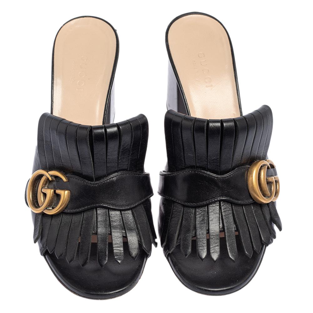 This pair of sandals by Gucci is a buy to wear and treasure. The sandals have been crafted from leather and styled with folded fringes and the brand's signature GG on the uppers. Open toes and a set of block heels complete this classy black pair.

