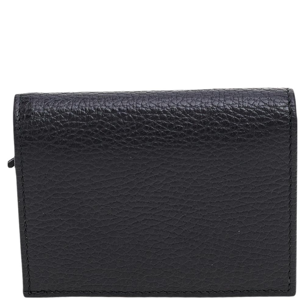 Coming from the House of Gucci, this Limited Edition Bosco card case is a lavish accessory that is worth the investment! It is made from black leather with a gold-toned GG motif and a Bosco accent perched on the front. This card case has multiple