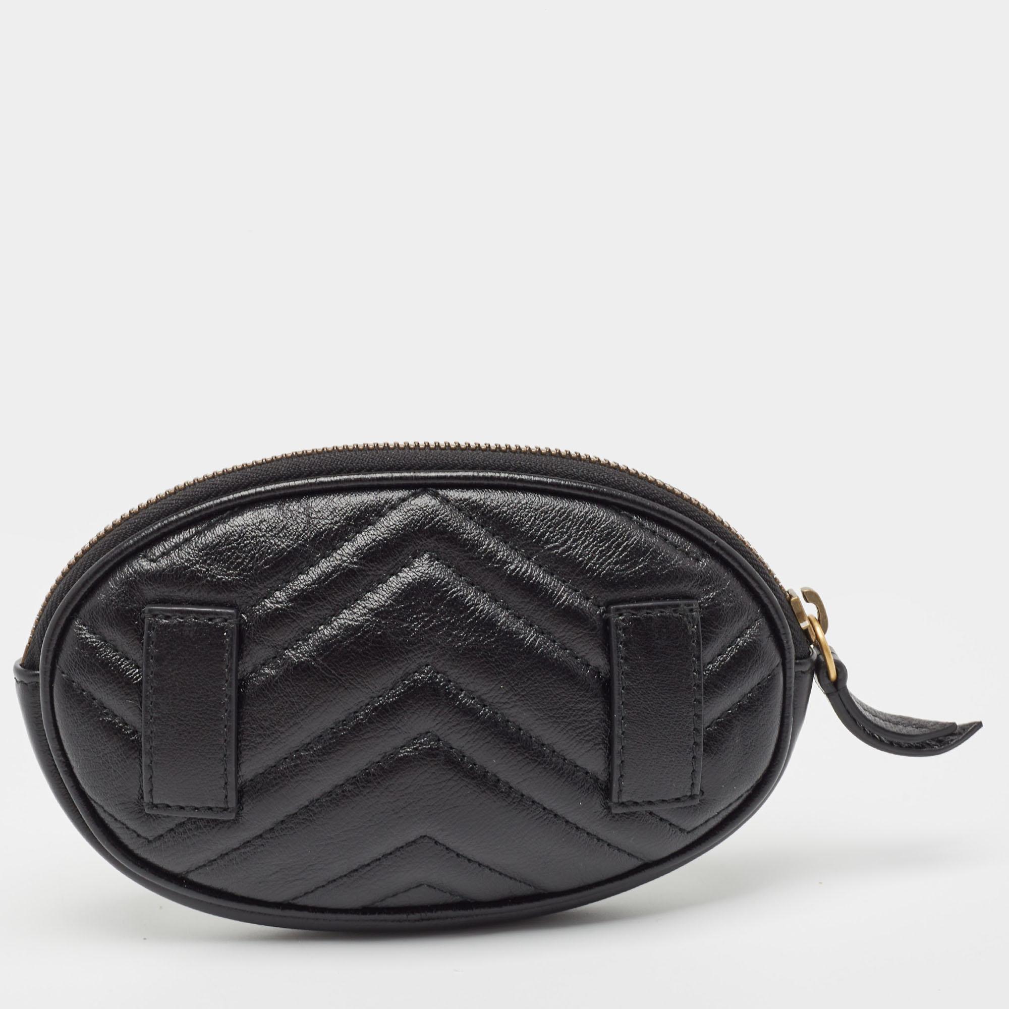 The Gucci pouch exudes elegance with its sleek black leather adorned with the iconic GG logo. Its compact yet functional design makes it perfect for carrying essentials with style. This luxurious accessory seamlessly merges fashion and practicality,