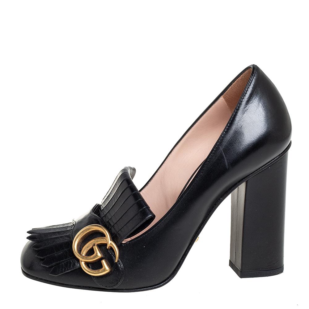 Pretty and easy to flaunt, this pair of Marmont pumps by Gucci is a stunner. They've been crafted from black leather and styled with folded fringes with the brand's signature GG on the uppers. Square toes, low heels, and sturdy leather soles