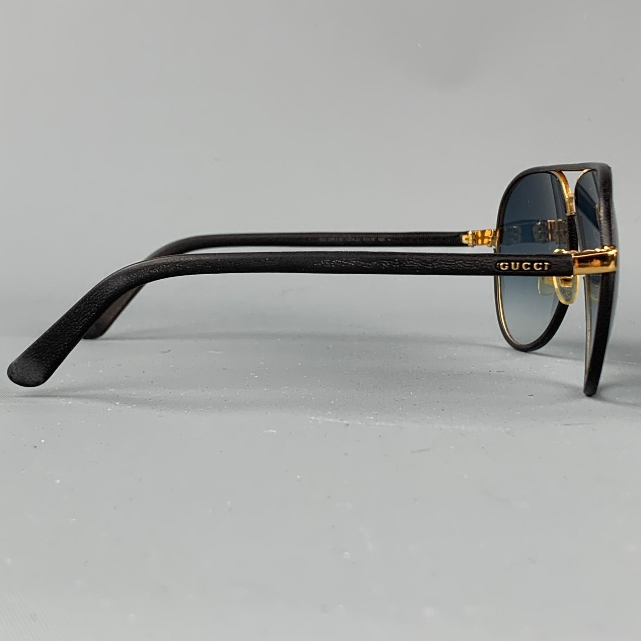 GUCCI sunglasses comes in a black leather with gold tone hardware featuring a aviator style and tinted lenses. Comes with case. Moderate wear. Made in Italy. 

Very Good Pre-Owned Condition.
Marked: GG 2887/S UZAJJ 61-11 140

Measurements:

Length: