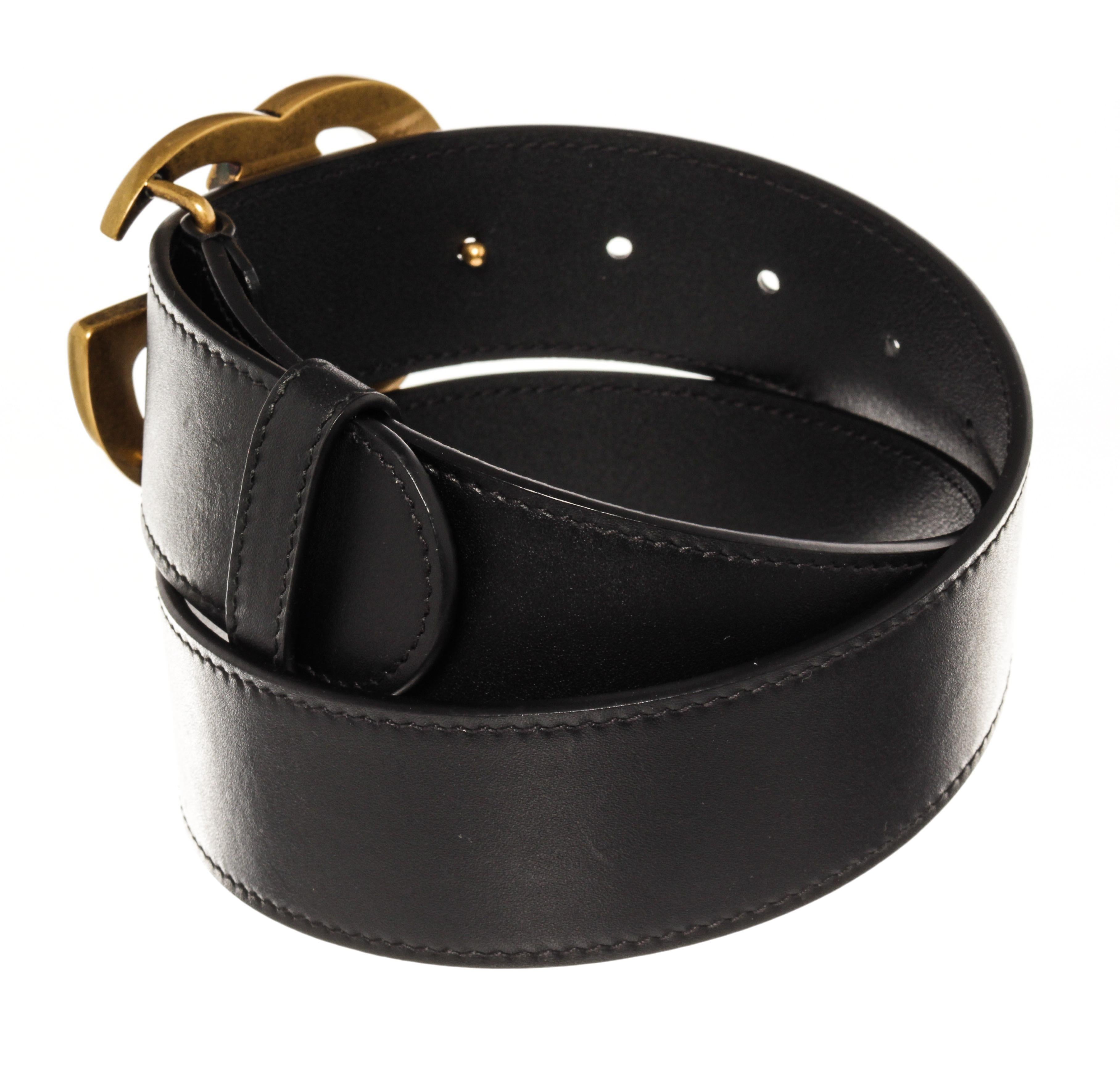 Gucci Black Leather Gold Wide GG Belt. Features black leather interior and exterior, and a gold hardware GG logo.

57365MSC