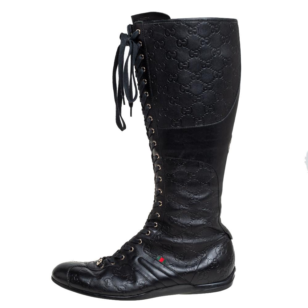 Let your latest shoe addition be this fabulous pair of knee-high boots from Gucci that will make you stand out in the crowd. The black boots are crafted from leather and feature Guccissima-patterned panels. They are designed with lace-ups, a GG logo