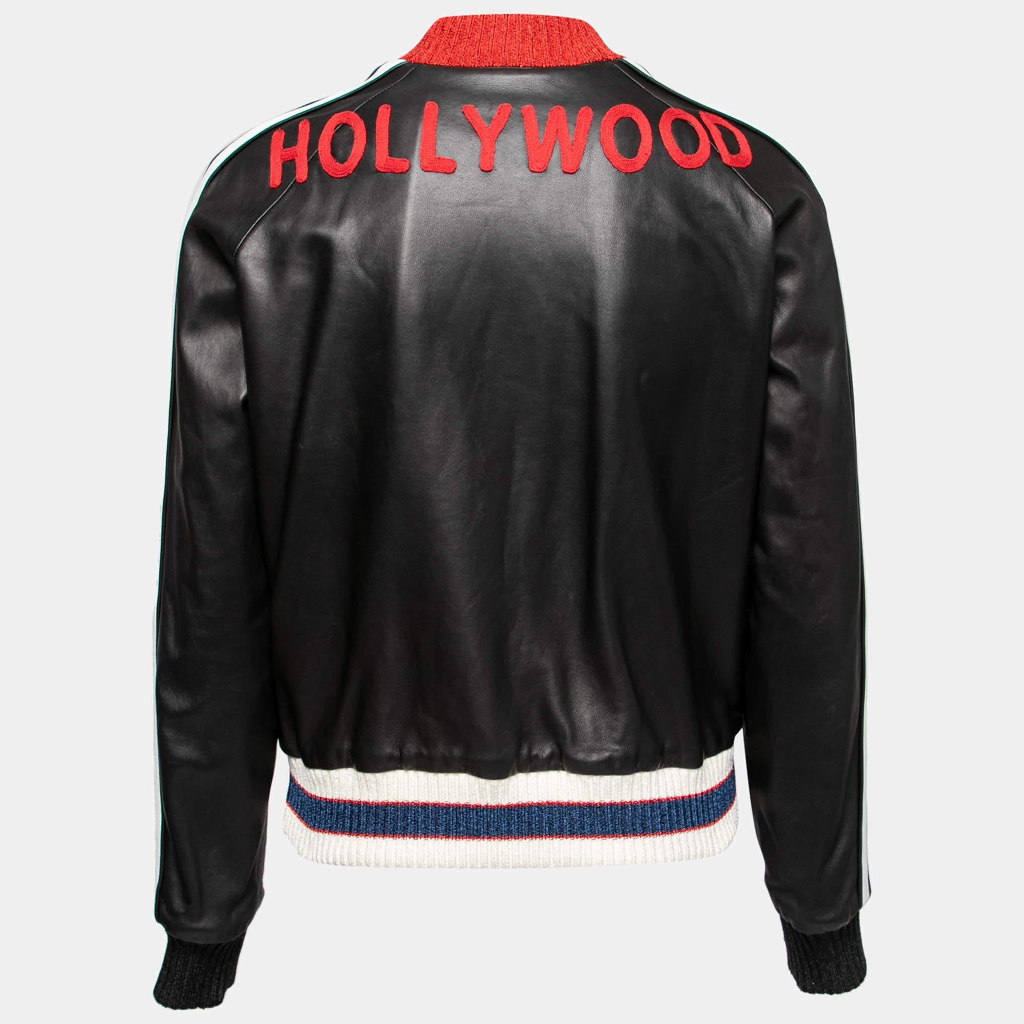 This Bomber jacket from the House of Gucci will help you sport a dapper style. It is designed using black leather, with Hollywood embroidery highlighting the back. It is embellished with gold-tone buttons and contrasting trims. This jacket